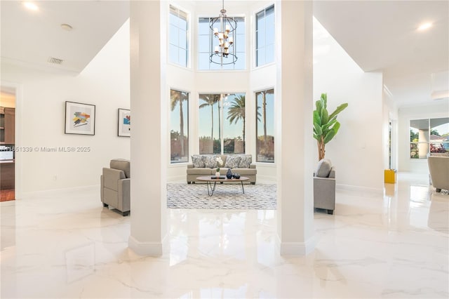14403 S Jockey Cir S, Davie, FL 33330 - foyer with marble tiled floors, plenty of natural light, a chandelier, and a high ceiling