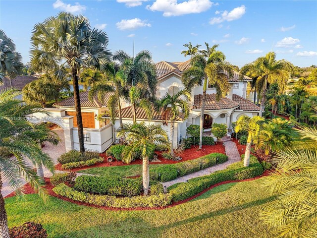 14403 S Jockey Cir S, Davie, FL 33330 - mediterranean / spanish house with a tiled roof and stucco siding