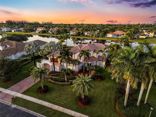 birds eye view of property featuring a water view and a residential view