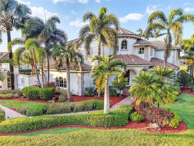 14403 S Jockey Cir S, Davie, FL 33330 - mediterranean / spanish house with stucco siding, a tiled roof, and a front lawn