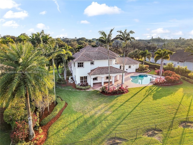 14403 S Jockey Cir S, Davie, FL 33330 - back of property with a fenced backyard, a patio area, a tile roof, stucco siding, and driveway