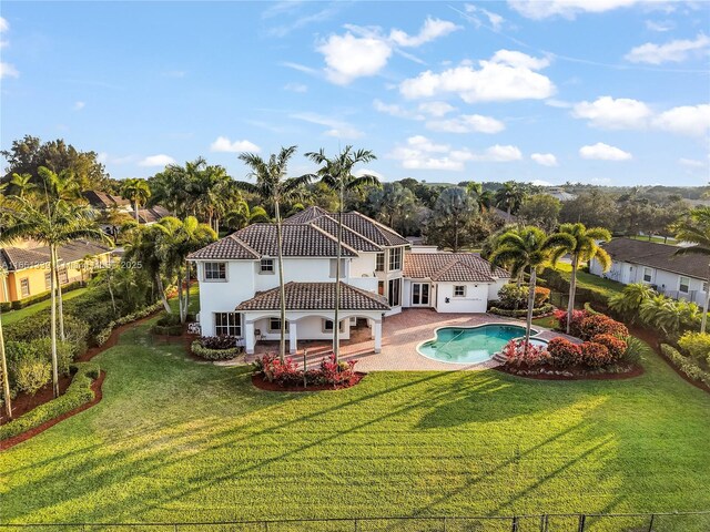 14403 S Jockey Cir S, Davie, FL 33330 - rear view of property featuring a patio area, stucco siding, and a tile roof