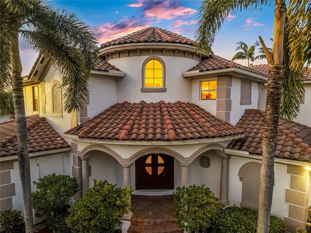 14403 S Jockey Cir S, Davie, FL 33330 - mediterranean / spanish house with a tiled roof and stucco siding