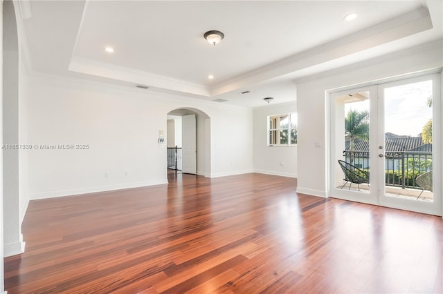 14403 S Jockey Cir S, Davie, FL 33330 - unfurnished room featuring arched walkways, a raised ceiling, french doors, wood finished floors, and ornamental molding