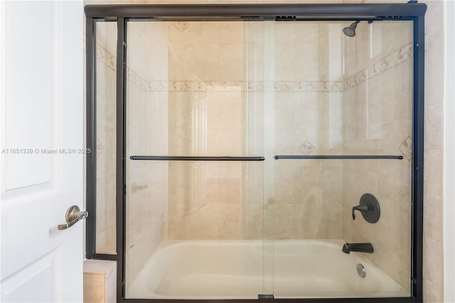 bathroom featuring shower / bath combination with glass door