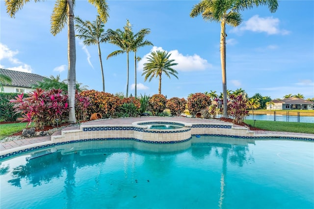 outdoor pool featuring a water view and an in ground hot tub