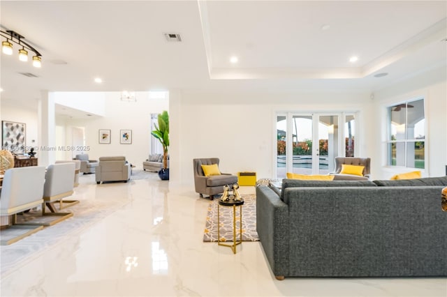 living area featuring french doors, marble finish floor, recessed lighting, a raised ceiling, and visible vents