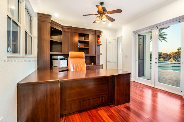 unfurnished office featuring a ceiling fan, crown molding, and wood finished floors