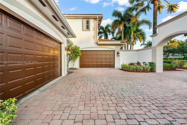 garage featuring decorative driveway