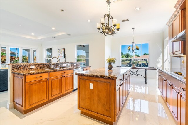 14403 S Jockey Cir S, Davie, FL 33330 - kitchen with a kitchen island with sink, a chandelier, light marble finish floors, healthy amount of natural light, and ornamental molding