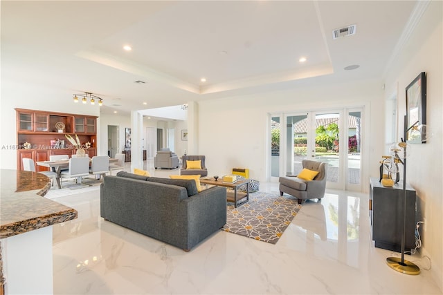 living area with french doors, a raised ceiling, visible vents, and crown molding