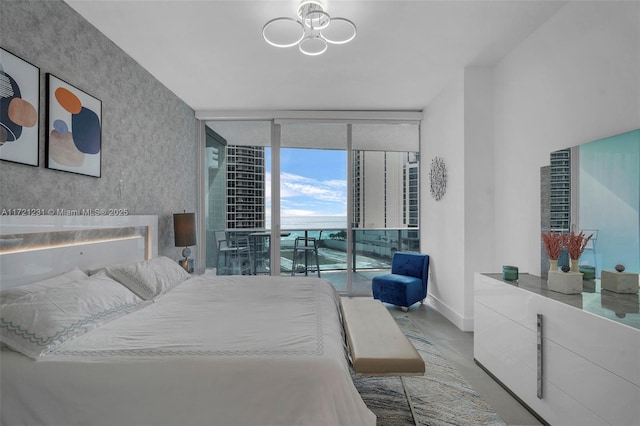 bedroom featuring access to outside and floor to ceiling windows