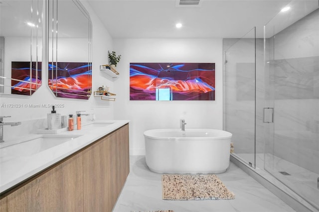 bathroom featuring vanity and independent shower and bath