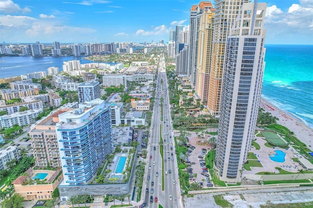 birds eye view of property with a water view and a view of the beach