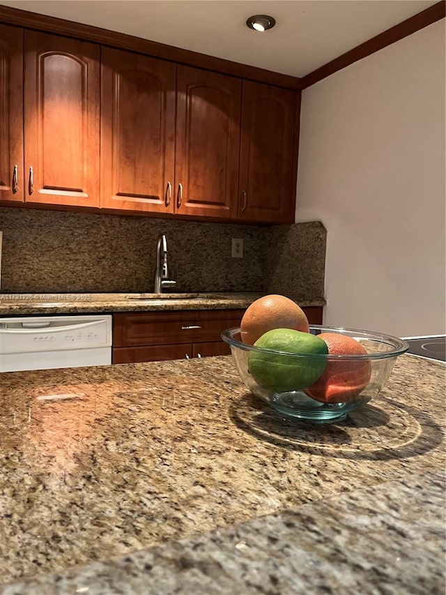 kitchen featuring stone countertops, sink, decorative backsplash, ornamental molding, and white dishwasher