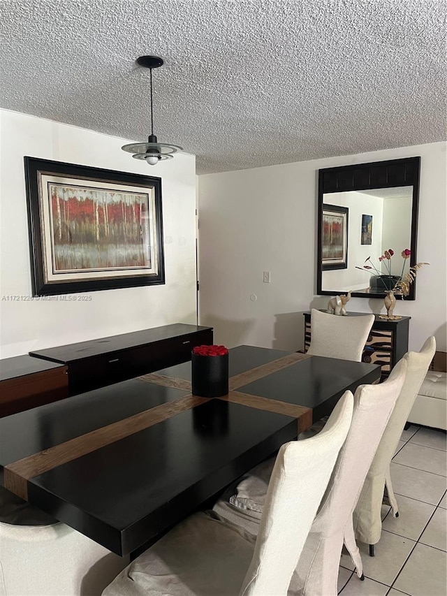 dining space with light tile patterned floors, a textured ceiling, and ceiling fan