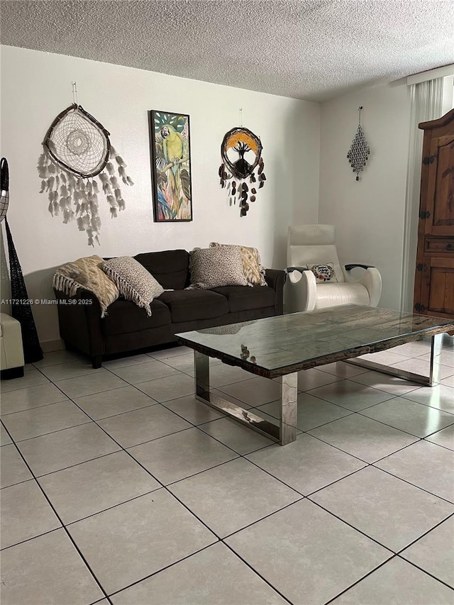 living area with a textured ceiling and tile patterned floors