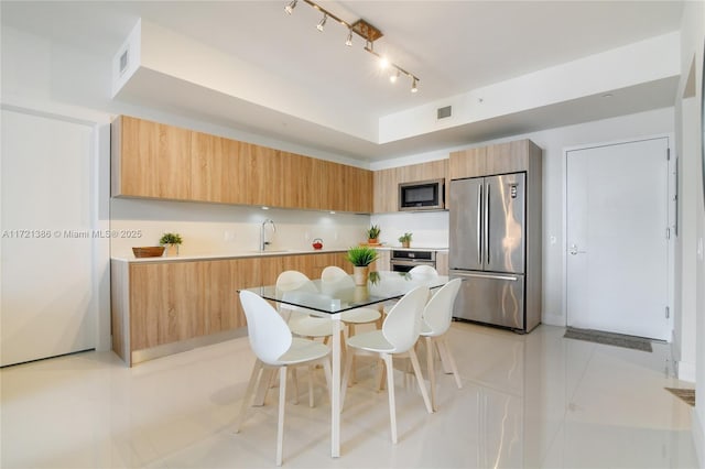 kitchen featuring light tile patterned floors, stainless steel appliances, and sink