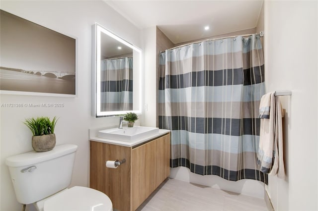 bathroom featuring curtained shower, vanity, and toilet