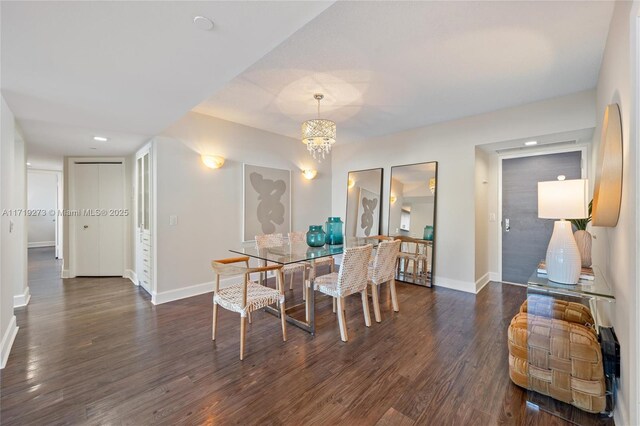 dining room featuring dark hardwood / wood-style floors and an inviting chandelier