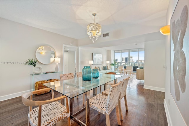 dining area featuring a chandelier and dark wood-type flooring