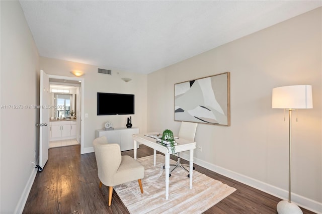 office with dark hardwood / wood-style flooring