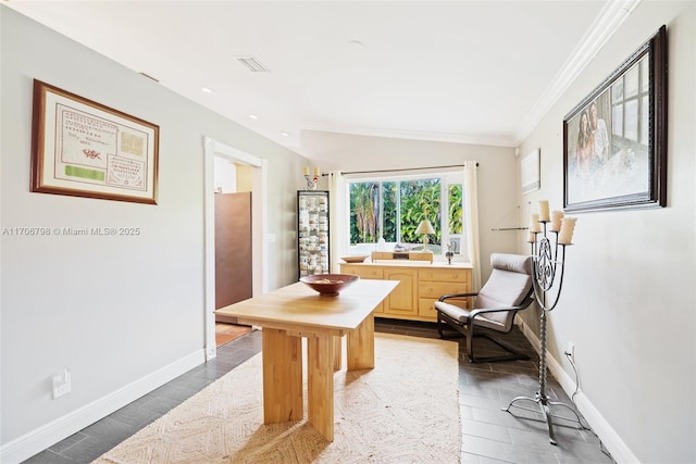 living area featuring ornamental molding and vaulted ceiling