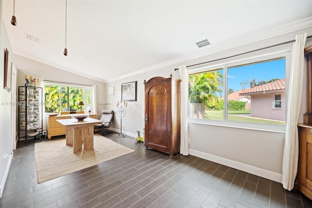 dining area featuring a healthy amount of sunlight, ornamental molding, and vaulted ceiling