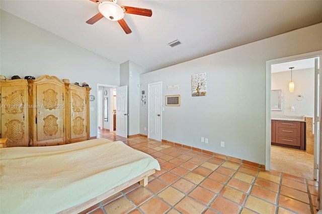 tiled bedroom featuring ensuite bath, ceiling fan, and lofted ceiling