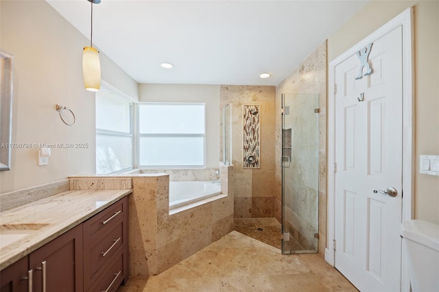 bathroom with vanity and separate shower and tub