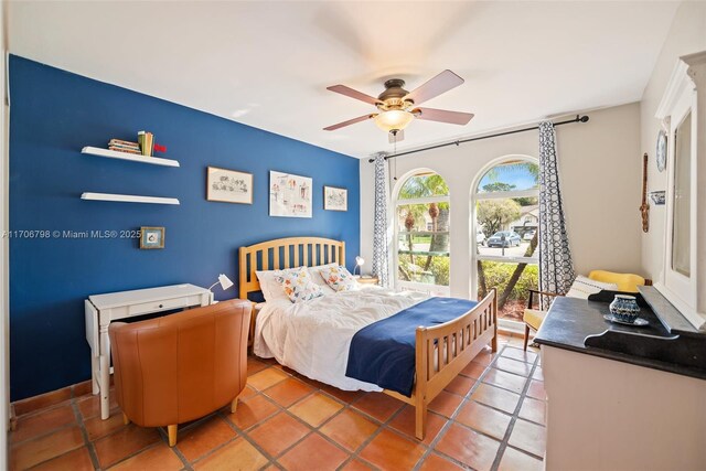 tiled bedroom featuring ceiling fan