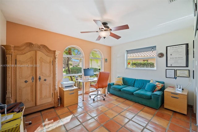 tiled office space featuring ceiling fan