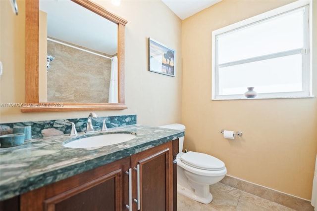 bathroom featuring a shower with shower curtain, vanity, toilet, and tile patterned flooring