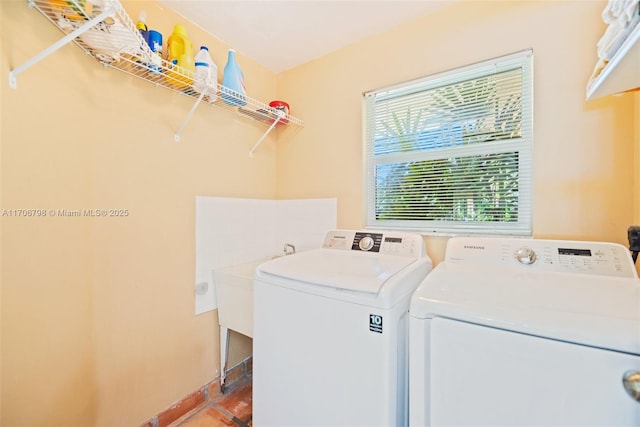 laundry area with tile patterned floors and washing machine and clothes dryer