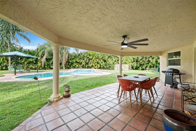 view of patio with ceiling fan and a grill