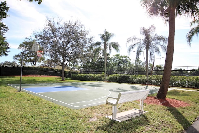 view of sport court featuring a lawn