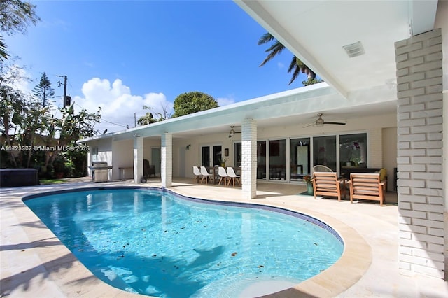 view of pool featuring ceiling fan, a patio, and grilling area