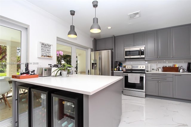 kitchen featuring appliances with stainless steel finishes, backsplash, gray cabinets, wine cooler, and hanging light fixtures