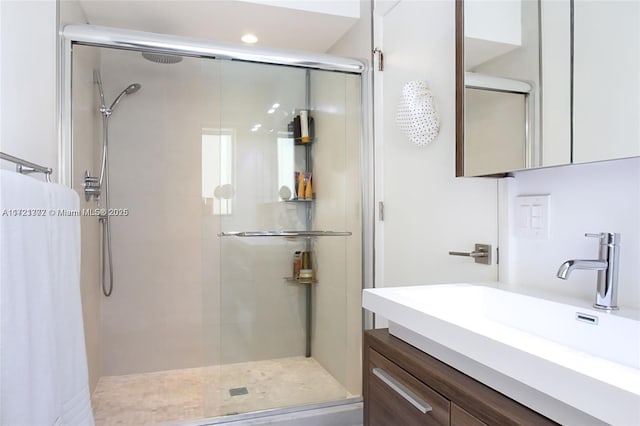 bathroom featuring vanity and a shower with door