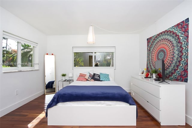 bedroom with dark wood-type flooring