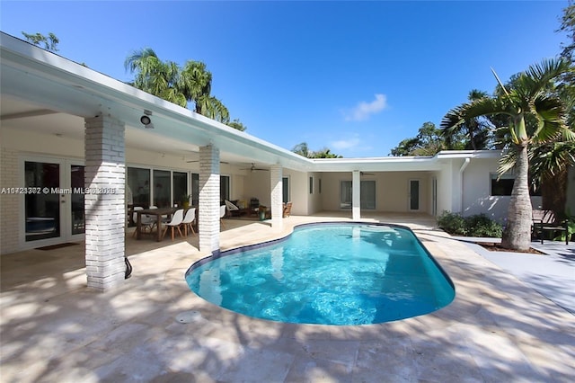 view of swimming pool featuring french doors, ceiling fan, and a patio area