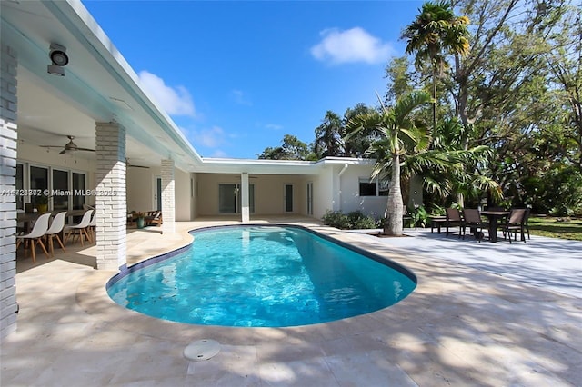 view of swimming pool with ceiling fan and a patio area