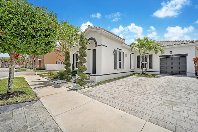 mediterranean / spanish home featuring a garage