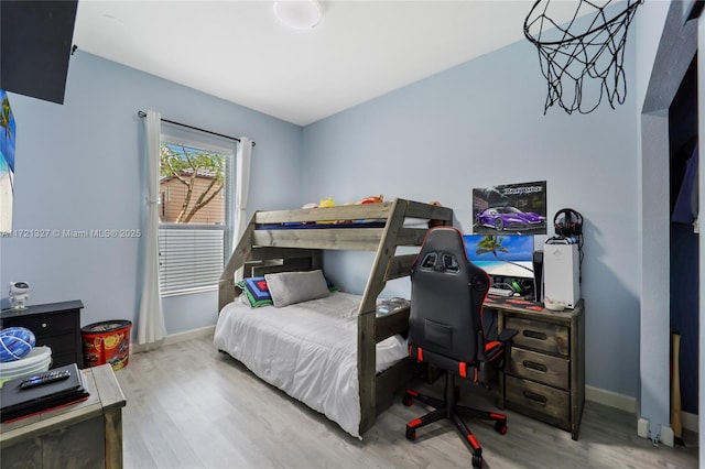 bedroom with hardwood / wood-style flooring