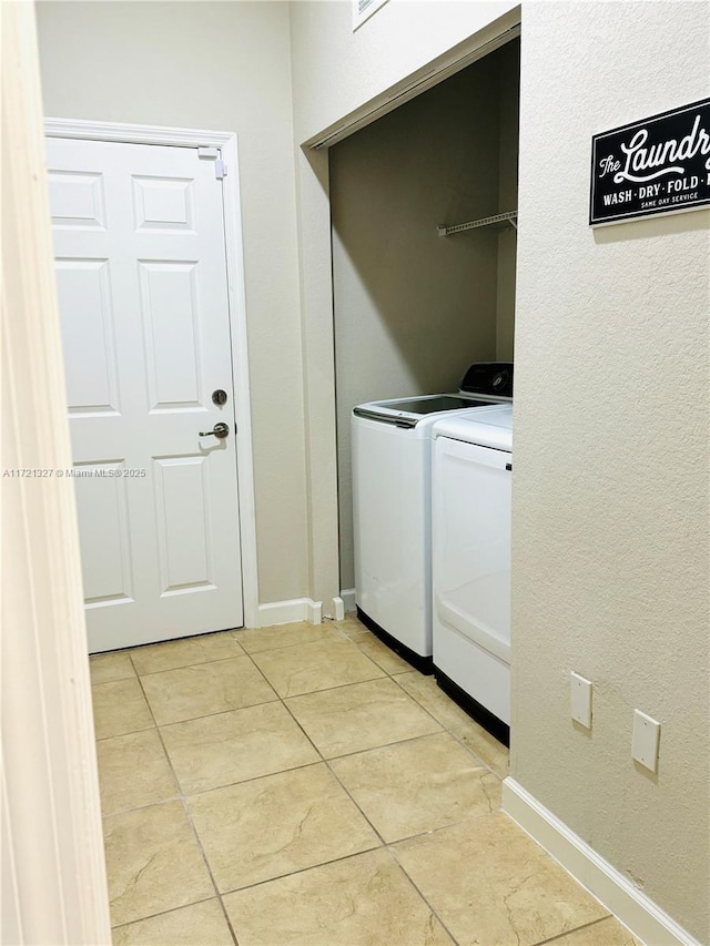 washroom with washing machine and dryer and light tile patterned floors