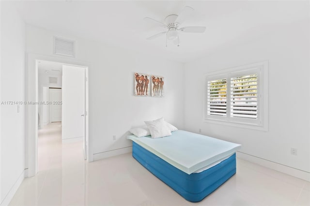 tiled bedroom featuring ceiling fan