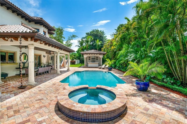 view of pool with ceiling fan, a patio area, and an in ground hot tub