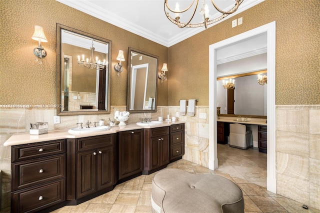 bathroom featuring crown molding, vanity, and tile walls