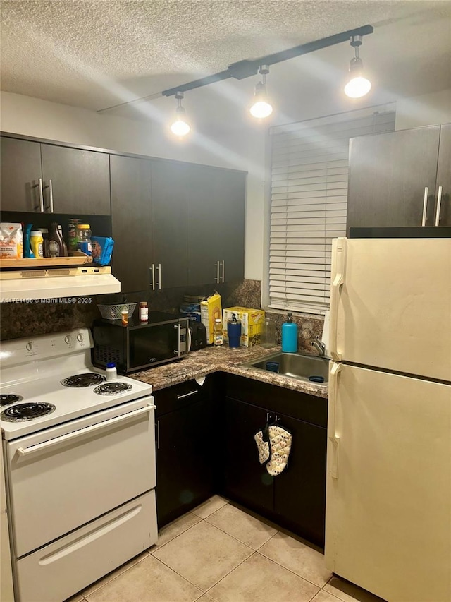 kitchen featuring white appliances, sink, a textured ceiling, light tile patterned flooring, and extractor fan