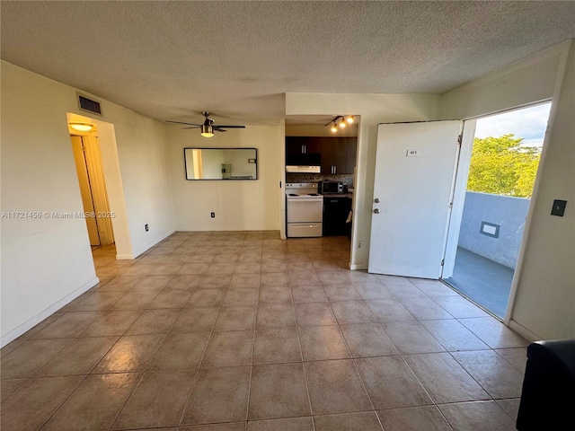 unfurnished living room with baseboards, ceiling fan, visible vents, and a textured ceiling